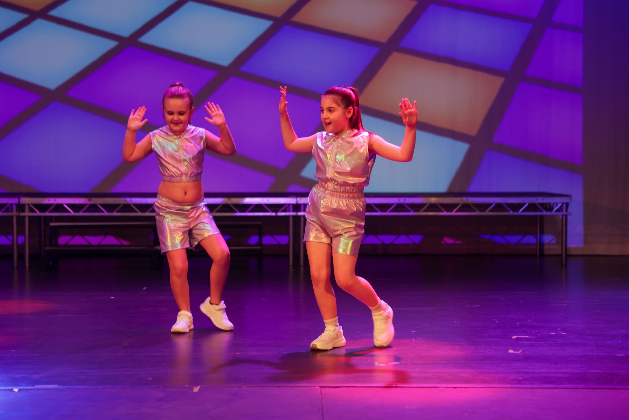 Two young dancers performing together on stage