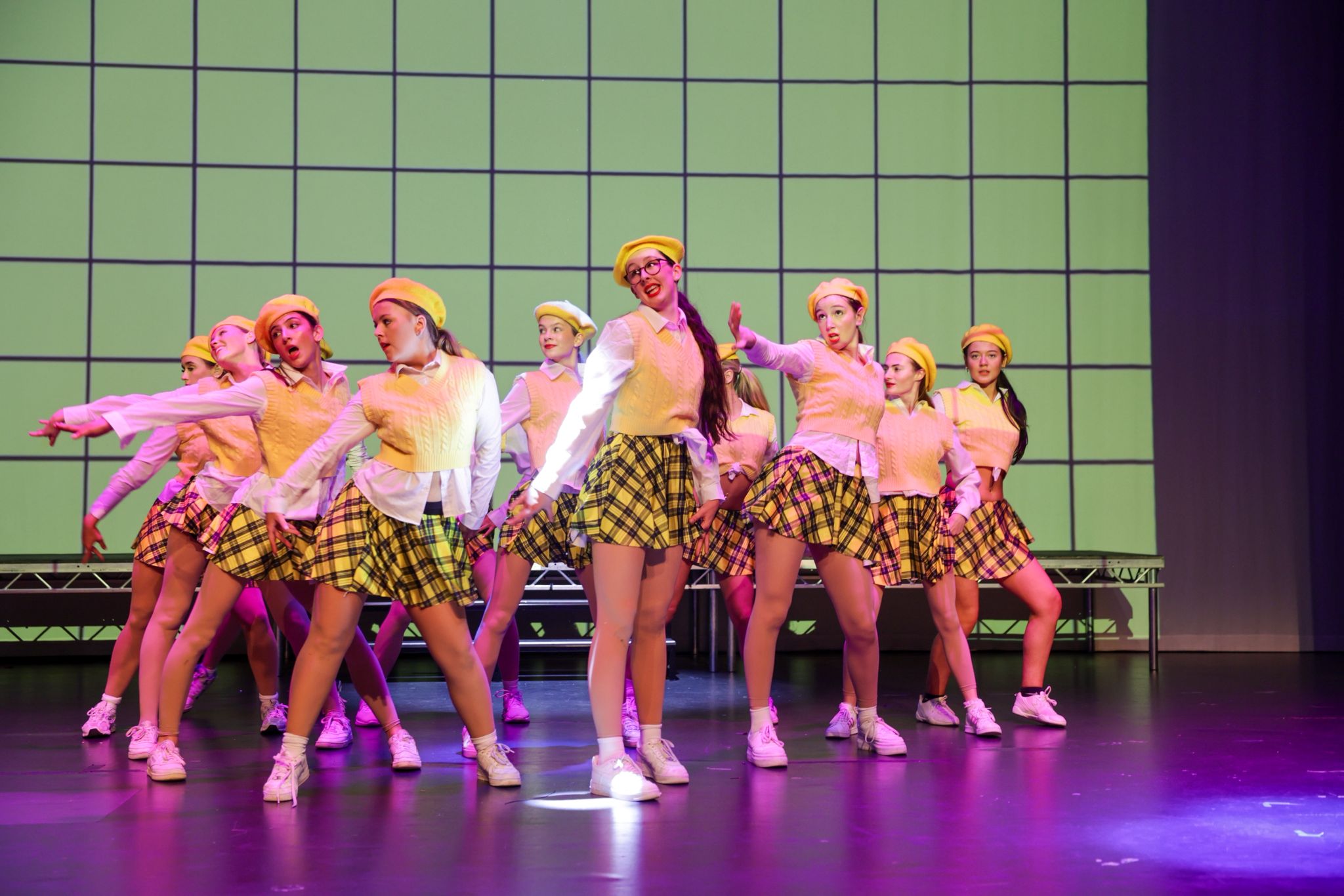 Group routine in yellow berets and tartan skirts