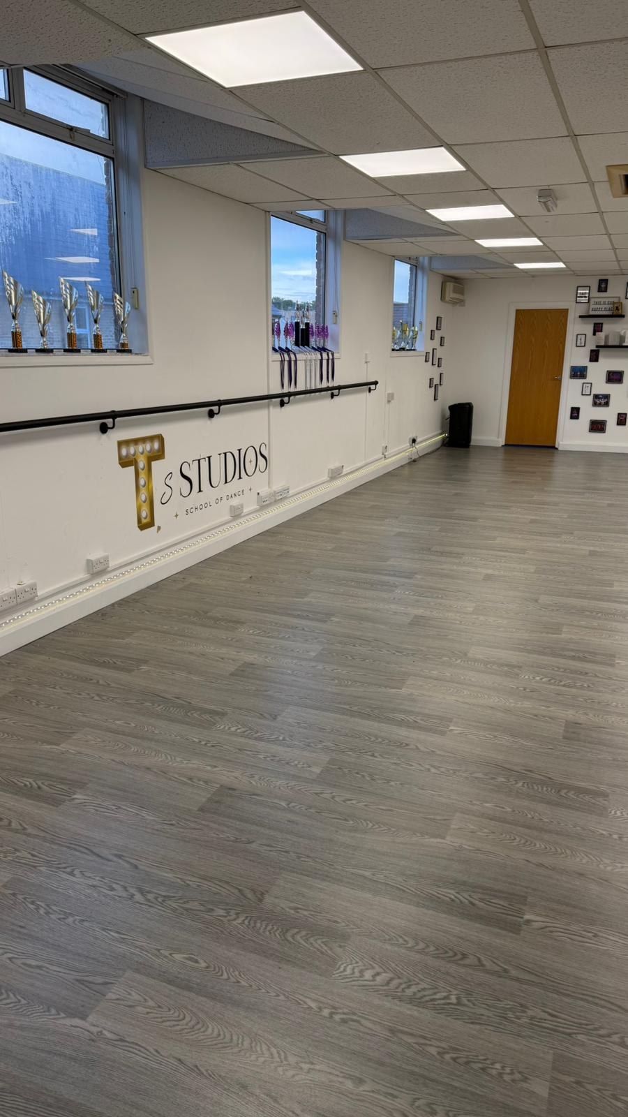 Ballet barre, trophy display and branded studio wall